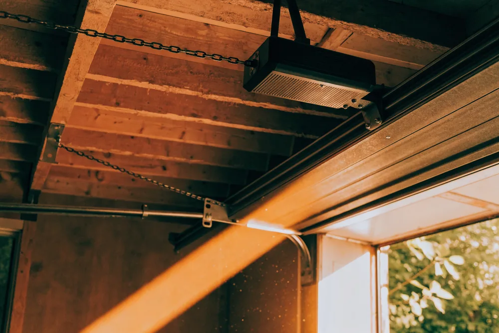 A ceiling-mounted chain-drive garage door opener
